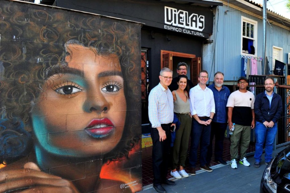 autoridades em frente a mural pintada em grafite